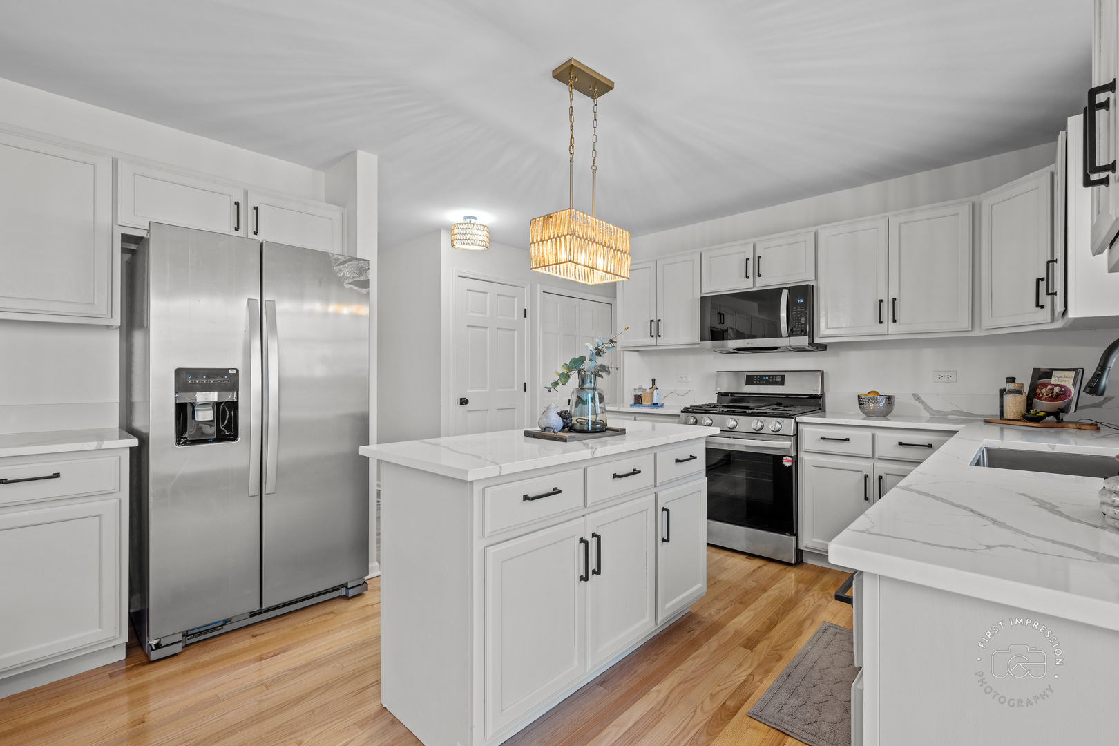 225 North Canterbury Road Aurora, IL 60506 - Photo 13 of 42 a kitchen with stainless steel appliances granite countertop a sink a stove a refrigerator cabinets and a dining table with wooden floor
