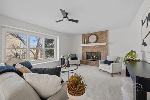 a living room with furniture and a fireplace