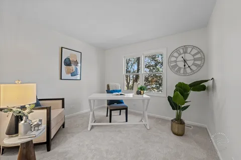 a view of a livingroom with furniture and a potted plant