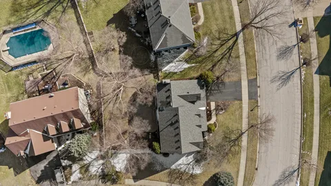 a aerial view of a house with a yard and garage
