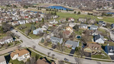 an aerial view of residential houses with outdoor space