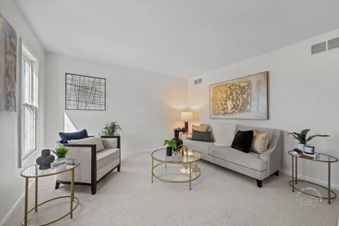 a living room with furniture and a potted plant on table
