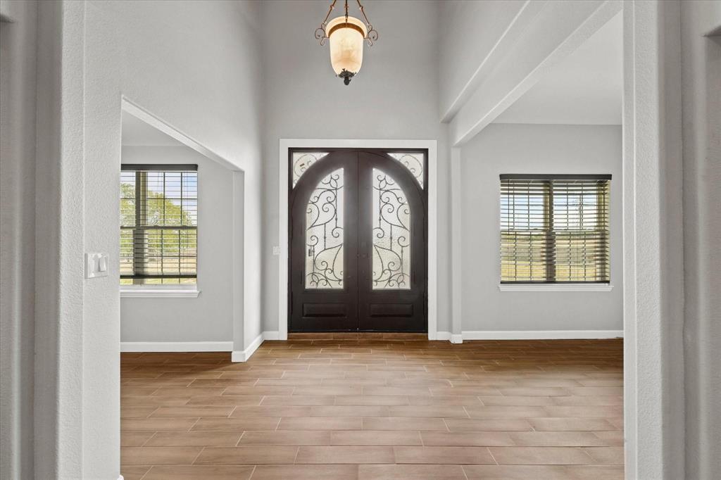 11170 Clear Creek Road West Sanger, TX 76266 - Photo 5 of 28 an empty room with wooden floor and windows
