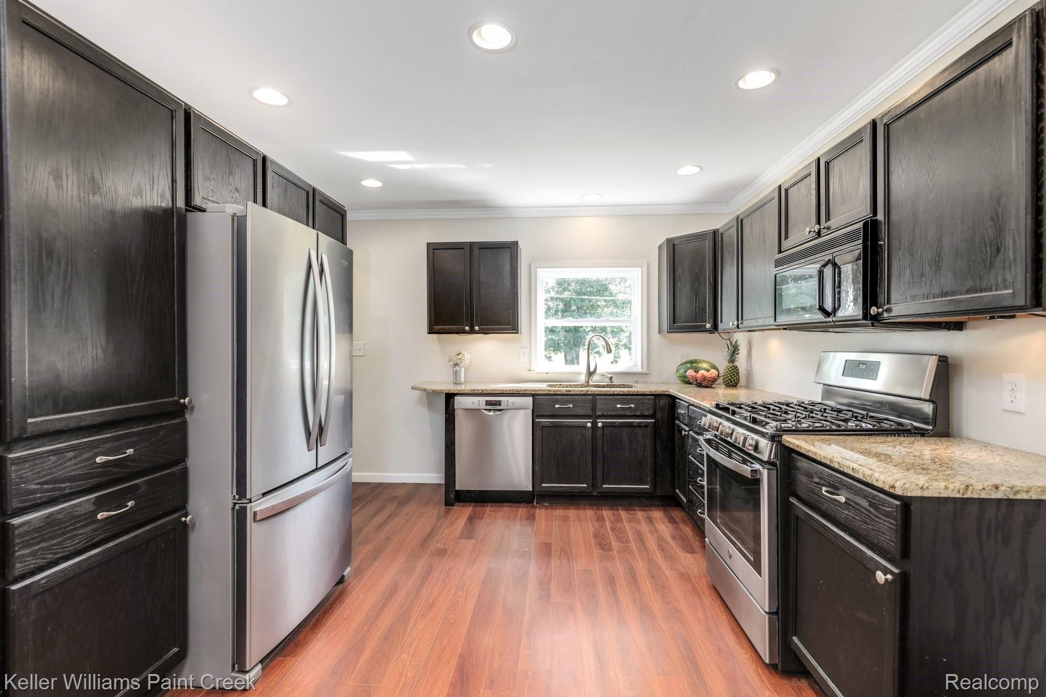 1146 East Gunn Road Rochester, MI 48306 - Photo 6 of 20 Updated kitchen with stainless steel appliances and good cabinet storage.