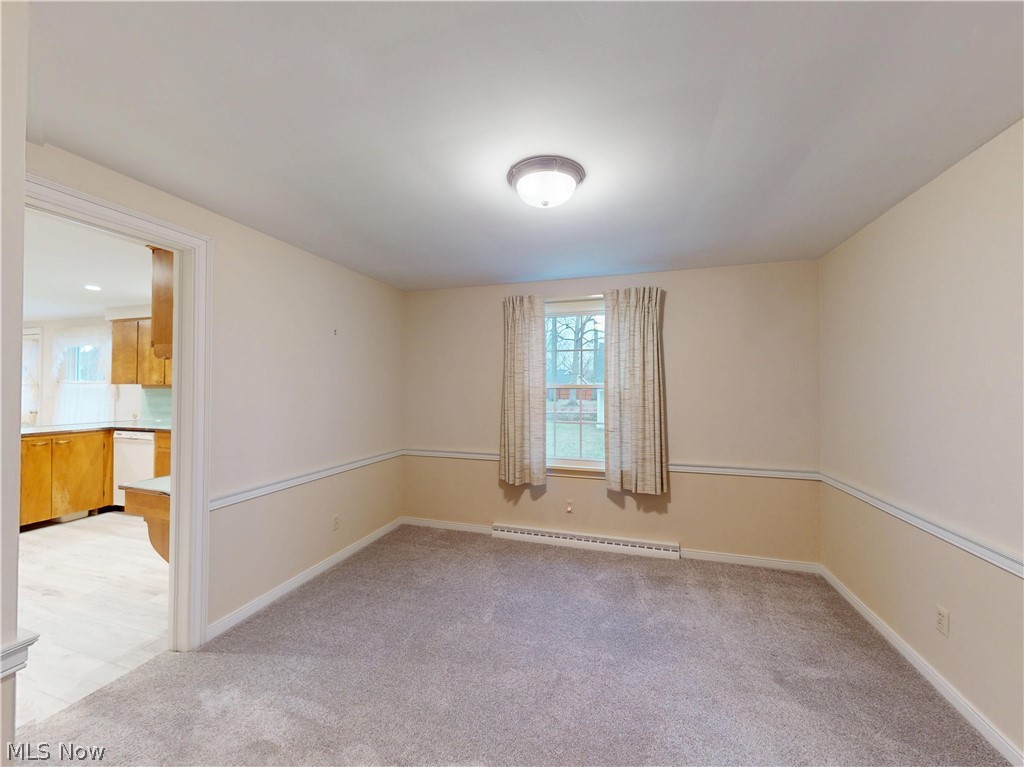 145 Overlook Road Painesville, OH 44077 - Photo 29 of 36 Spare room featuring light carpet and baseboard heating