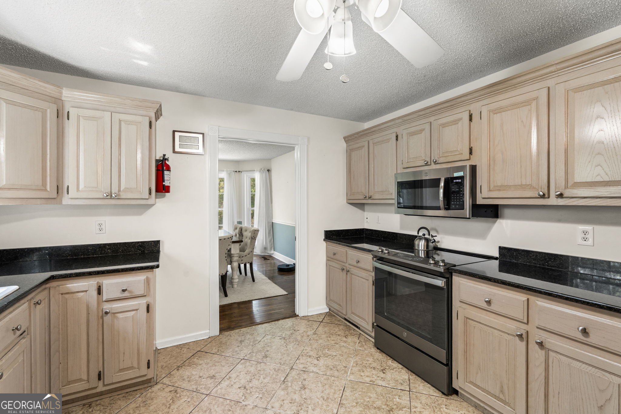 119 Moll Drive Cochran, GA 31014 - Photo 21 of 66 a kitchen with granite countertop white cabinets and stainless steel appliances