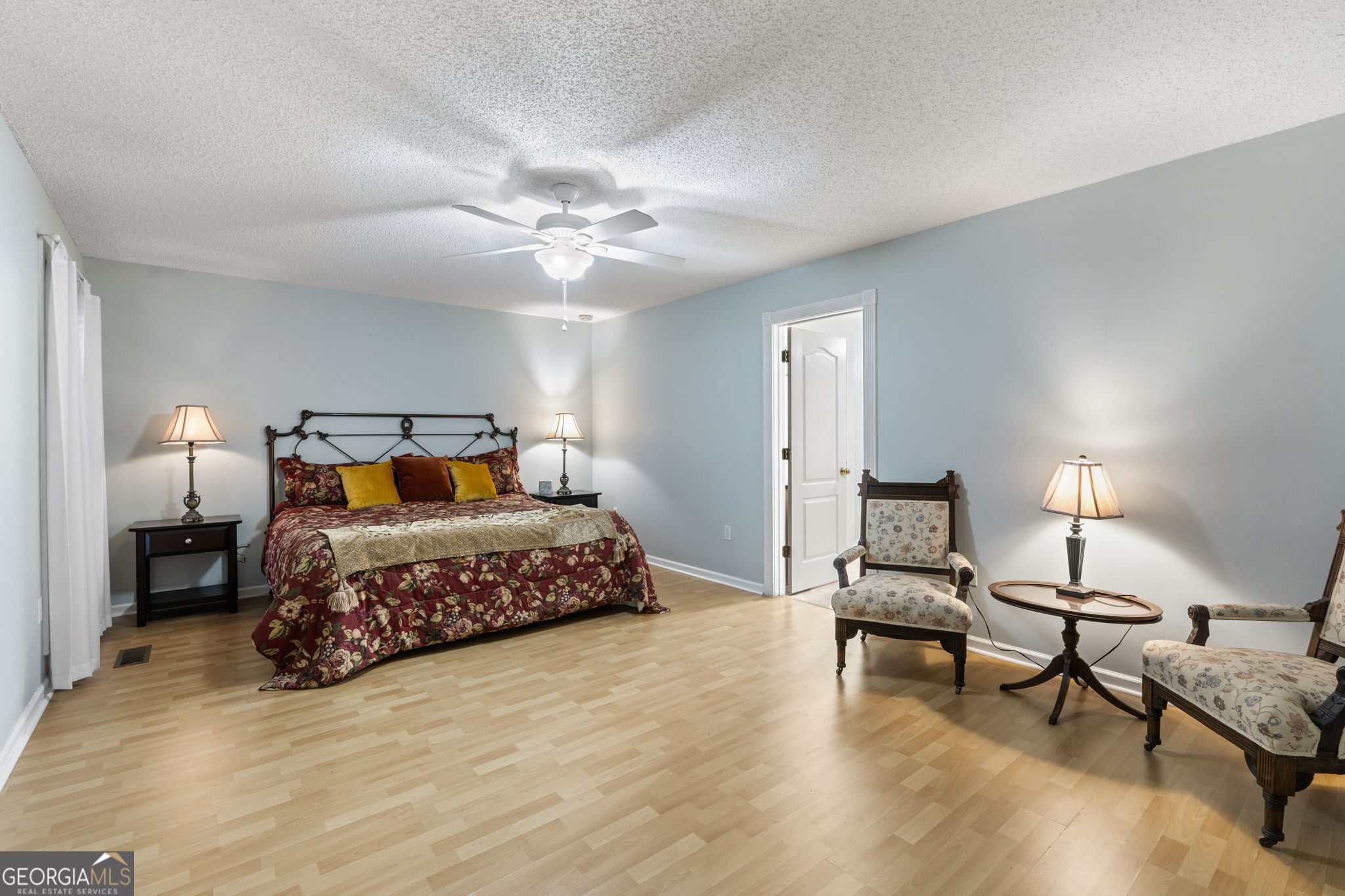119 Moll Drive Cochran, GA 31014 - Photo 29 of 66 a bedroom with a bed and a chandelier