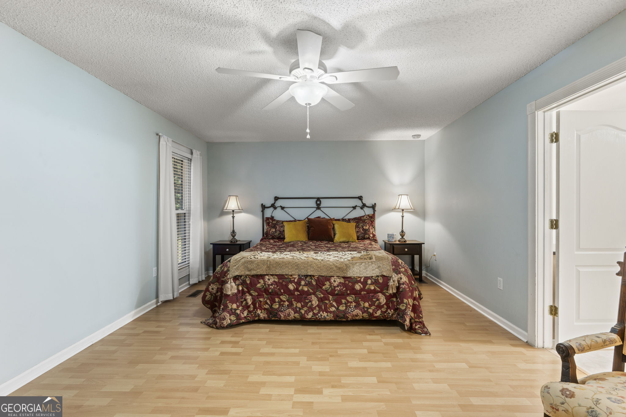 119 Moll Drive Cochran, GA 31014 - Photo 30 of 66 a bedroom with a bed and a chandelier