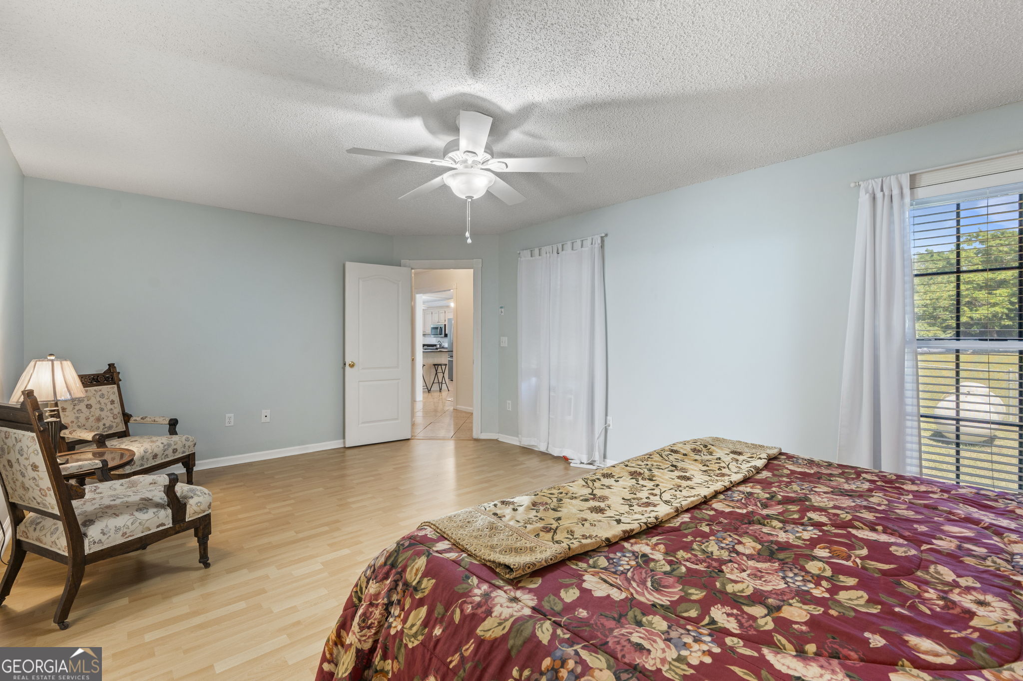 119 Moll Drive Cochran, GA 31014 - Photo 32 of 66 a bedroom with a bed and wooden floor