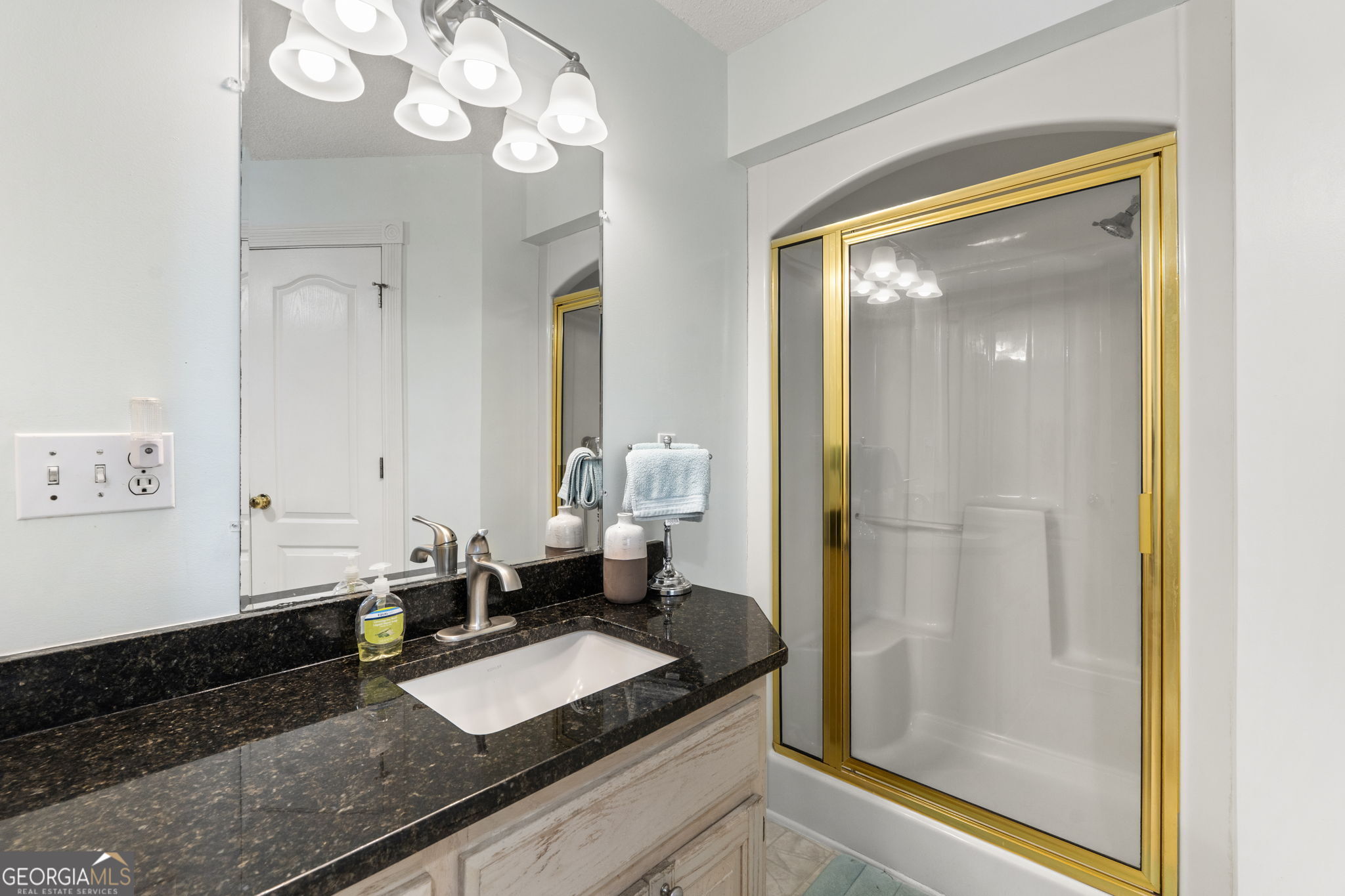 119 Moll Drive Cochran, GA 31014 - Photo 34 of 66 a bath room with a granite countertop sink and a mirror