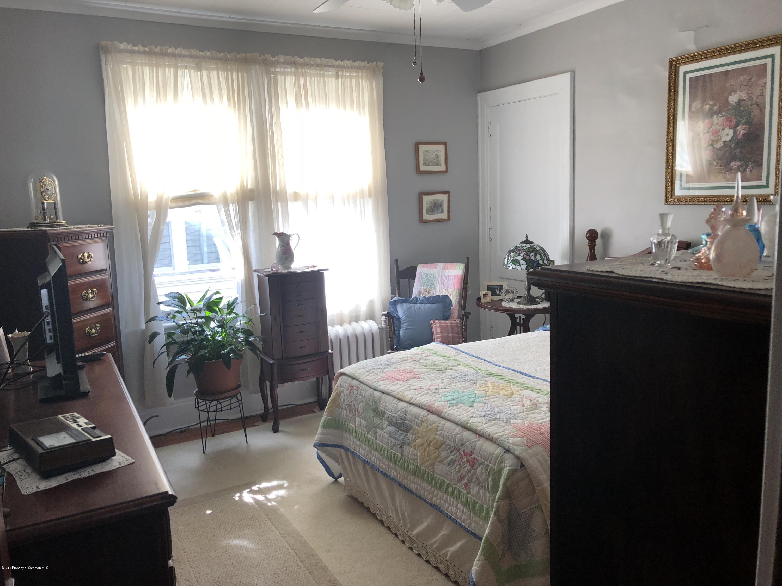 1640-1642 Farr Street Scranton, PA 18504 - Photo 4 of 12 a bedroom with a bed table chair and a window
