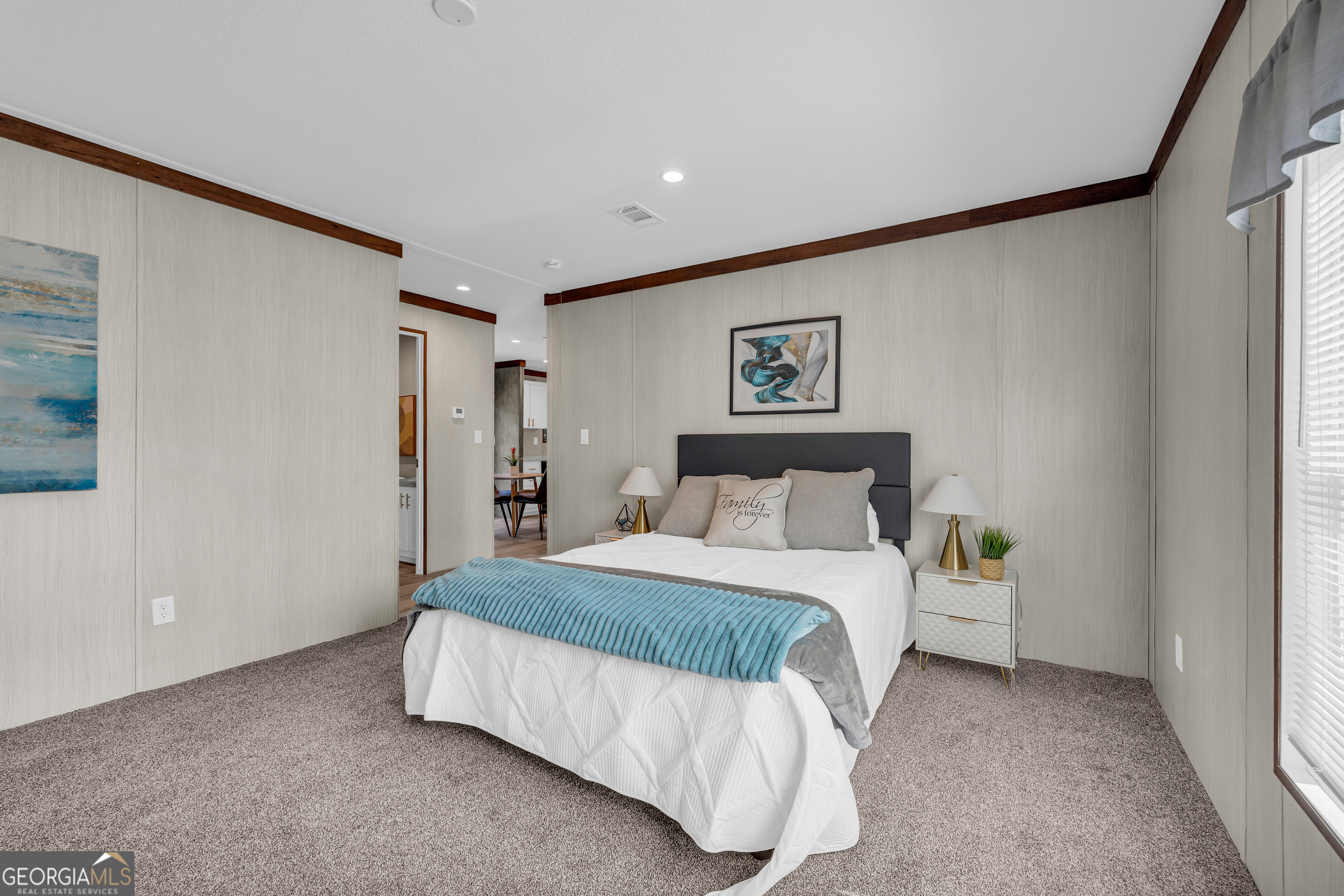 31 Dons Court Royston, GA 30662 - Photo 34 of 51 a spacious bedroom with a bed and a painting on the wall