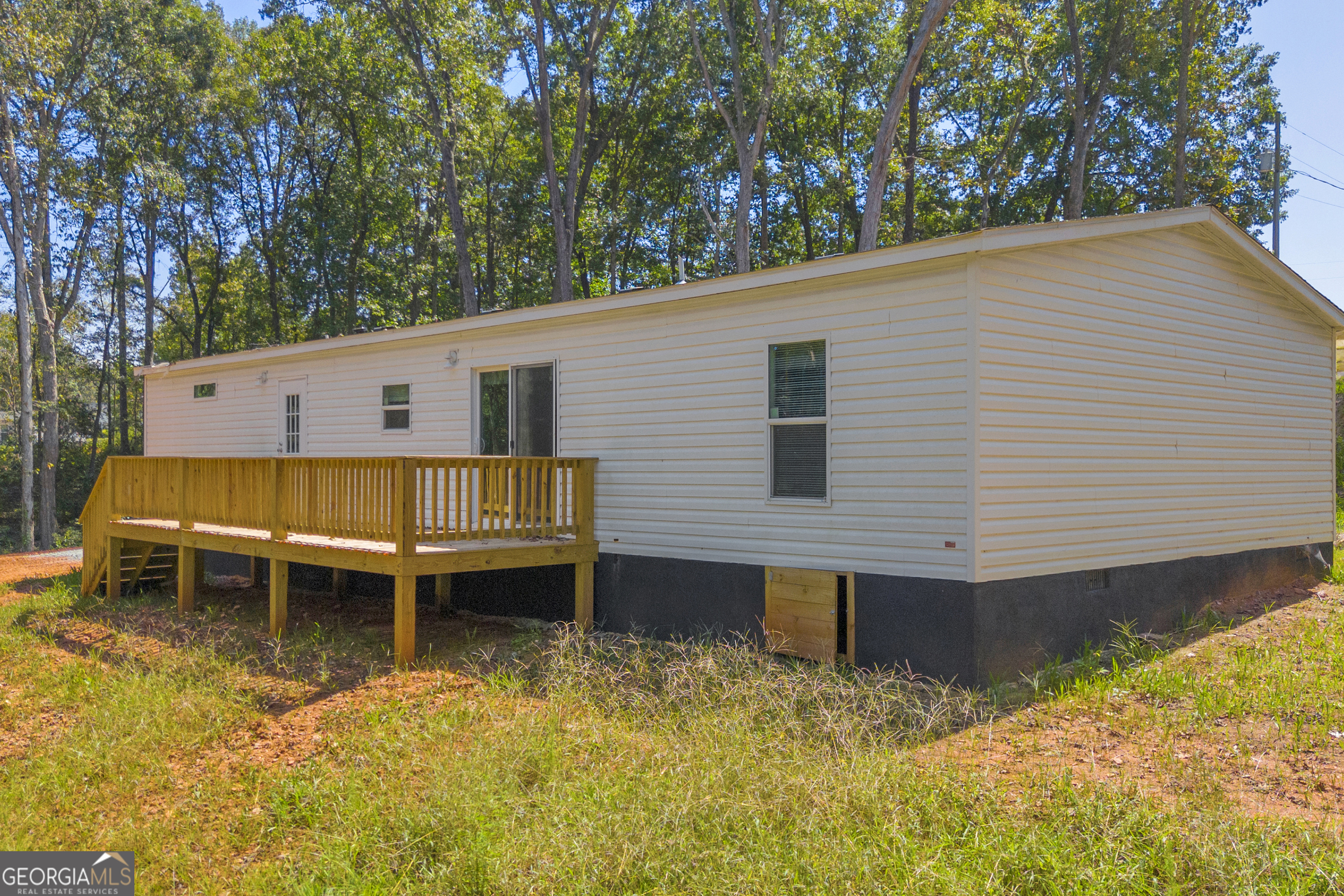 31 Dons Court Royston, GA 30662 - Photo 4 of 51 a backyard of a house with wooden deck and outdoor seating
