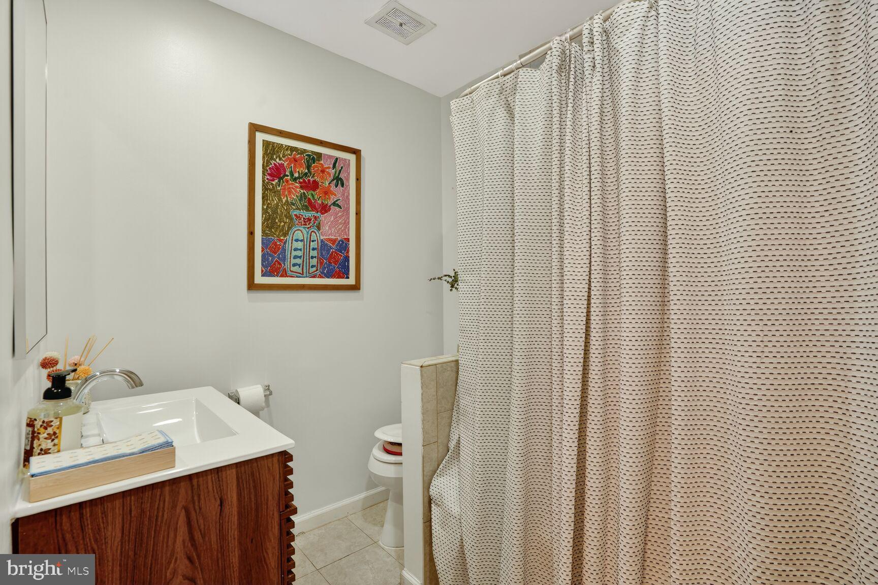4004 David Lane Alexandria, VA 22311 - Photo 22 of 25 a bathroom with a sink and a mirror