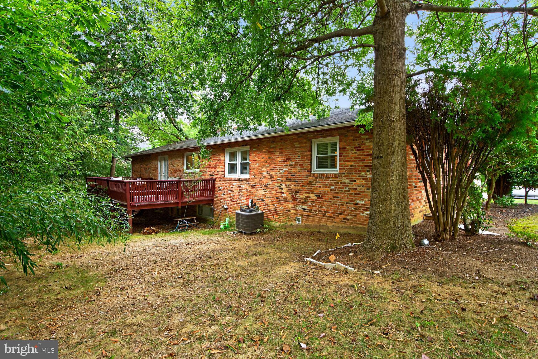 4004 David Lane Alexandria, VA 22311 - Photo 25 of 25 a view of backyard of house with wooden deck and seating space