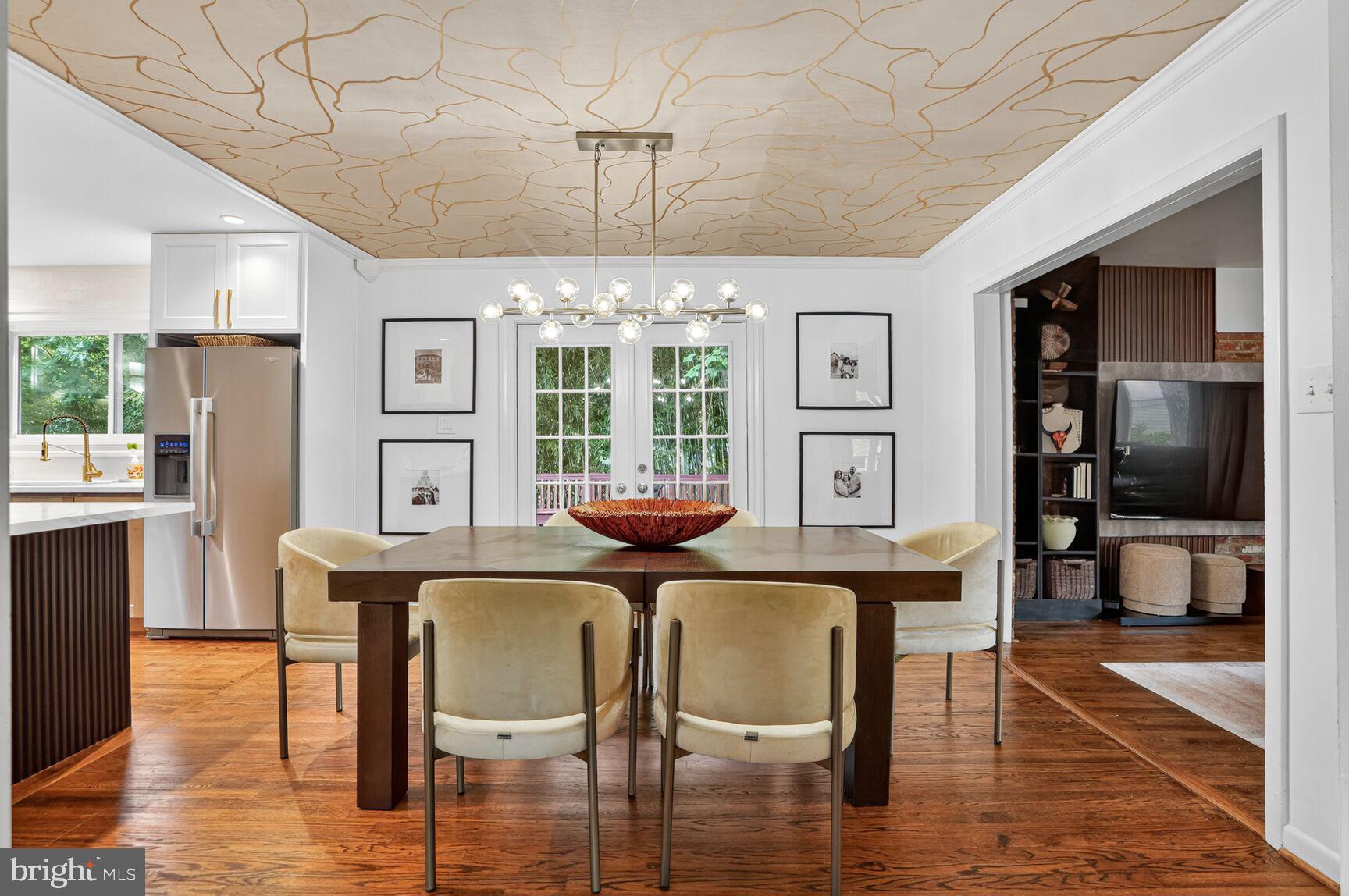 4004 David Lane Alexandria, VA 22311 - Photo 4 of 25 a dining room with furniture a chandelier and wooden floor
