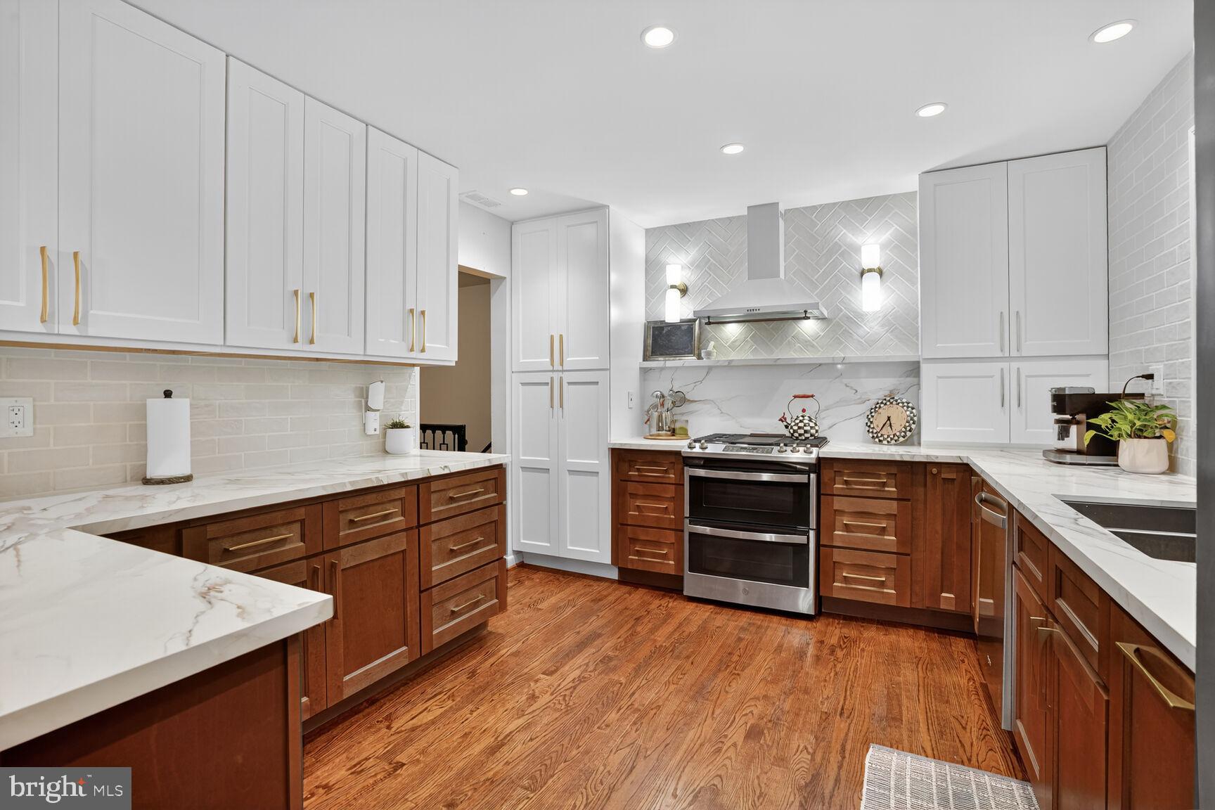 4004 David Lane Alexandria, VA 22311 - Photo 7 of 25 a kitchen with stainless steel appliances granite countertop a stove a sink and a refrigerator