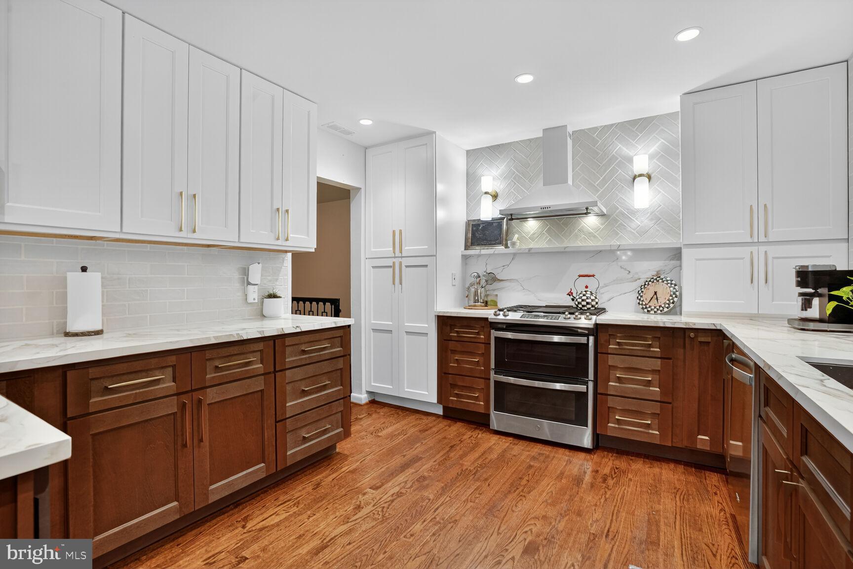 4004 David Lane Alexandria, VA 22311 - Photo 9 of 25 a kitchen with stainless steel appliances granite countertop a stove and cabinets