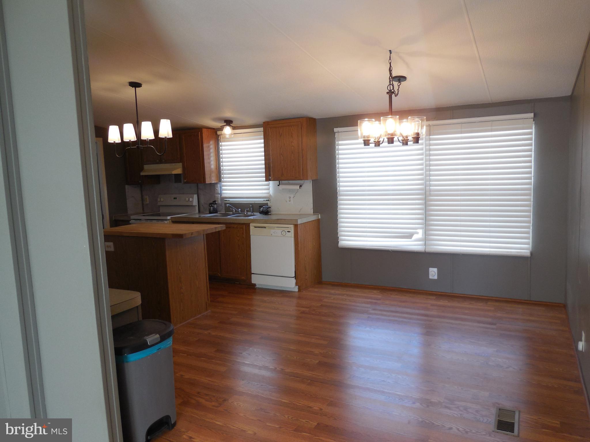 4041 Conowingo Road, Unit 14 Darlington, MD 21034 - Photo 11 of 27 a view of a kitchen with a sink wooden cabinets and a window