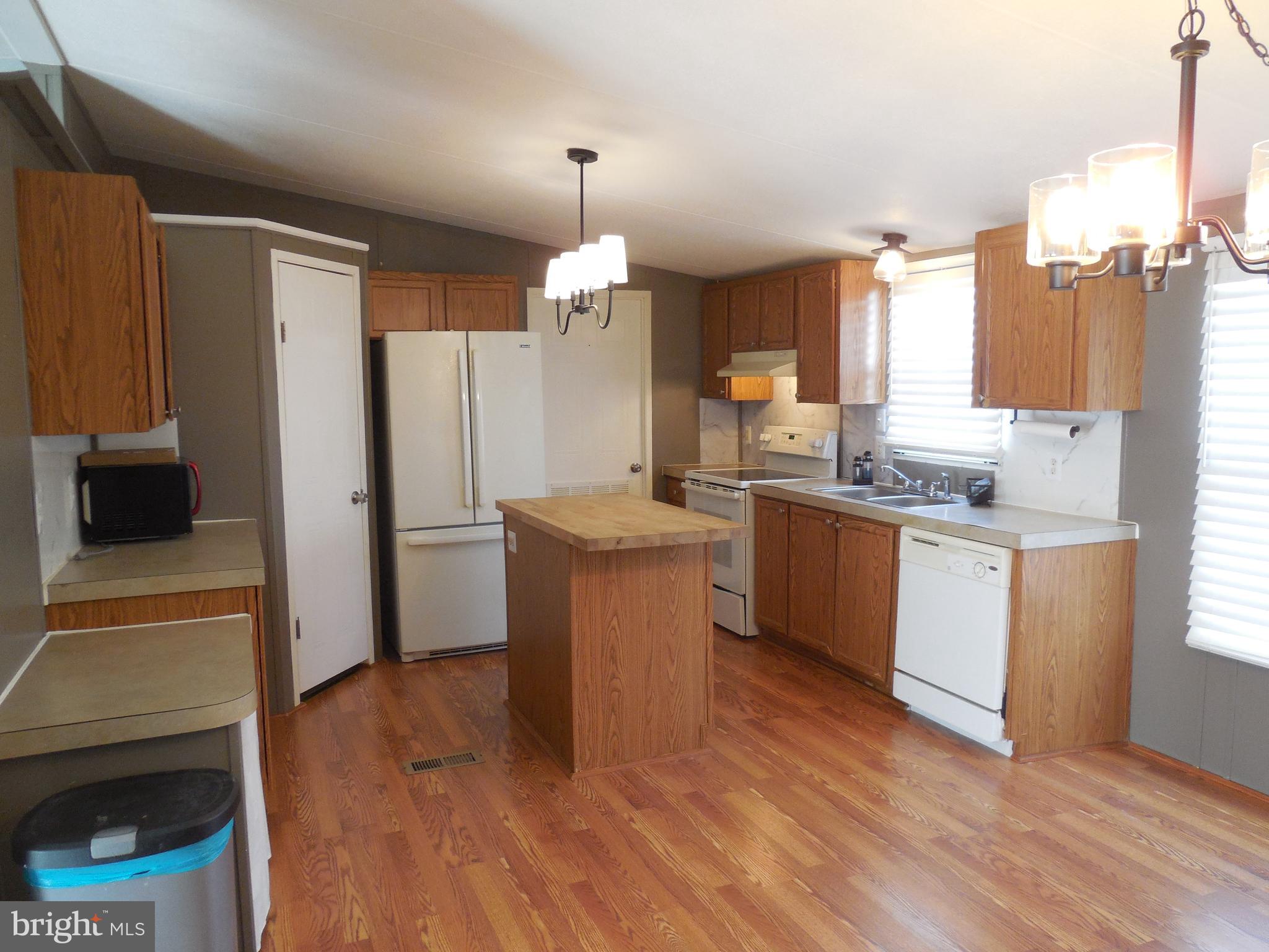 4041 Conowingo Road, Unit 14 Darlington, MD 21034 - Photo 12 of 27 a kitchen with a sink cabinets stainless steel appliances and a window