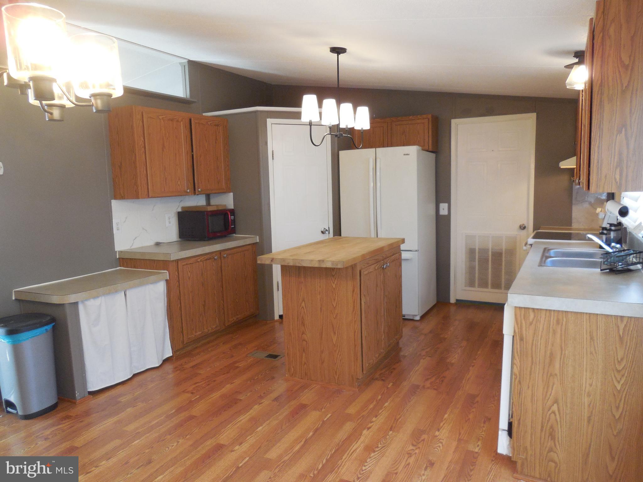 4041 Conowingo Road, Unit 14 Darlington, MD 21034 - Photo 13 of 27 a kitchen that has a lot of cabinets and wooden floor