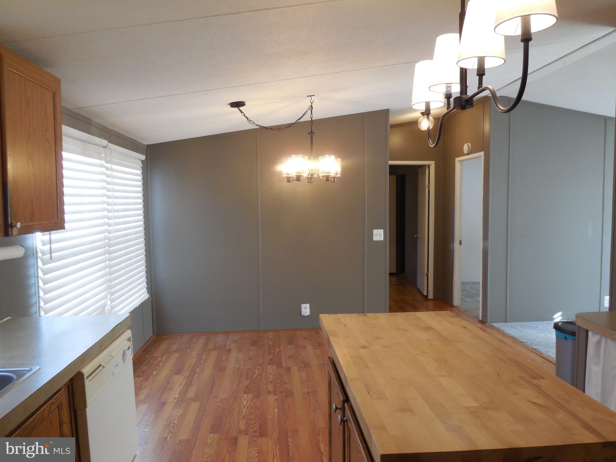 4041 Conowingo Road, Unit 14 Darlington, MD 21034 - Photo 14 of 27 a bedroom with a bed and a chandelier