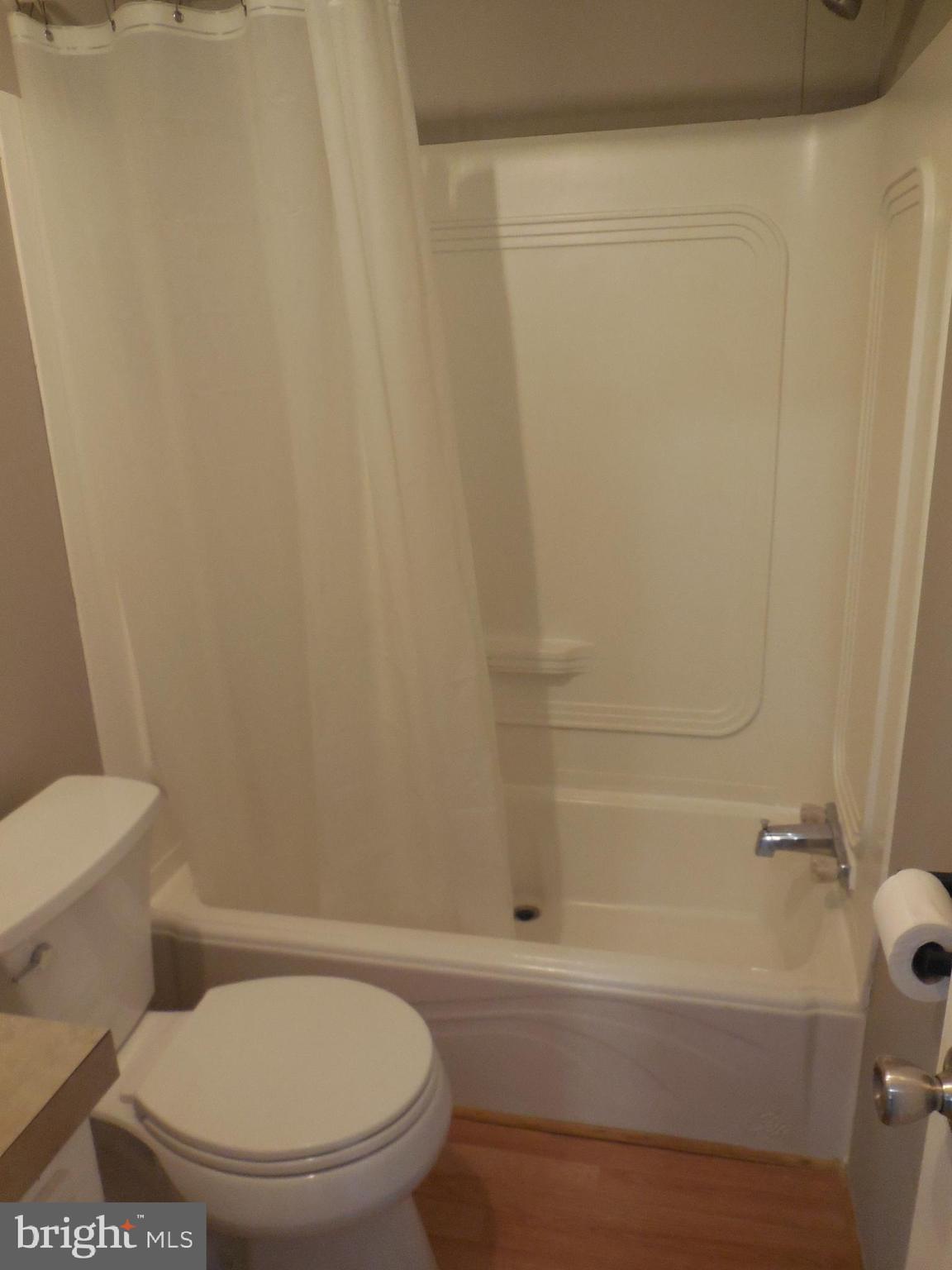 4041 Conowingo Road, Unit 14 Darlington, MD 21034 - Photo 17 of 27 a white toilet sitting next to a bath tub