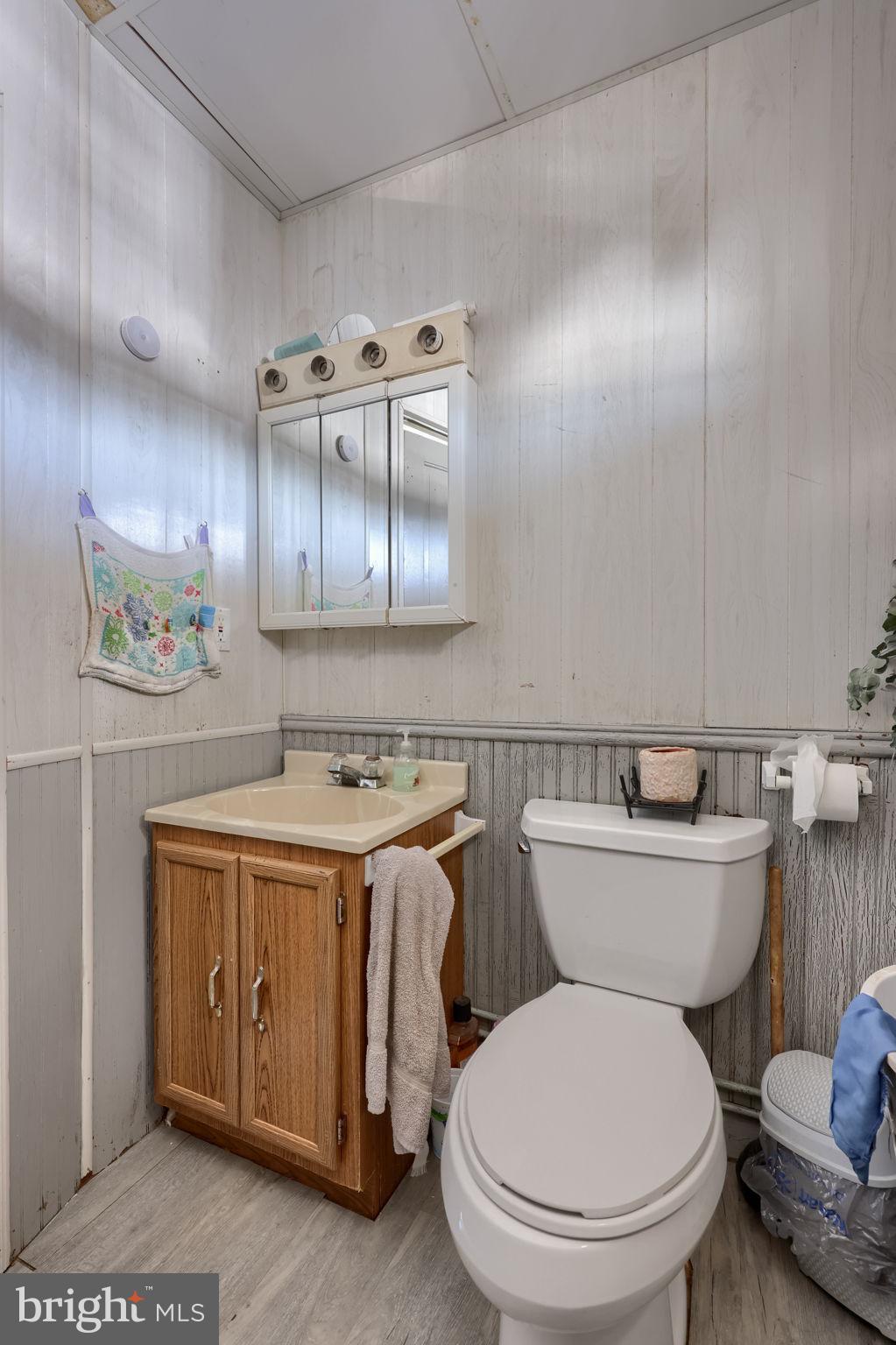 1001 Kirchner Road New Freedom, PA 17349 - Photo 32 of 37 a bathroom with a toilet a sink and wooden cabinets