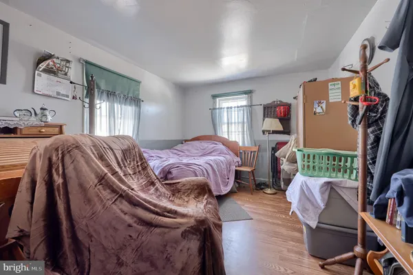 a view of a bedroom with furniture and window