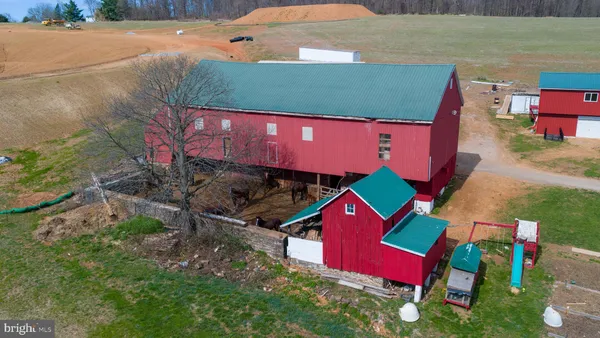 a view of a house with pool and a yard