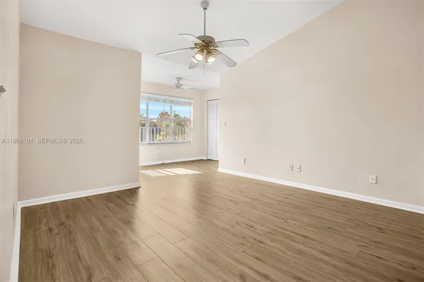 wooden floor in an empty room with a window