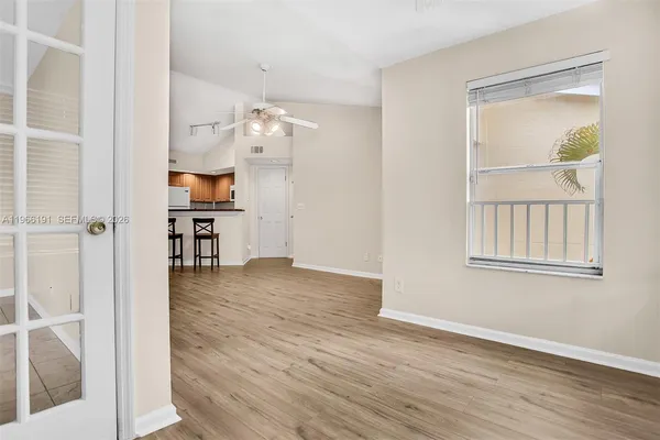 an empty room with wooden floor and a window