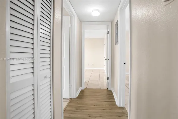 a view of a hallway with wooden floor