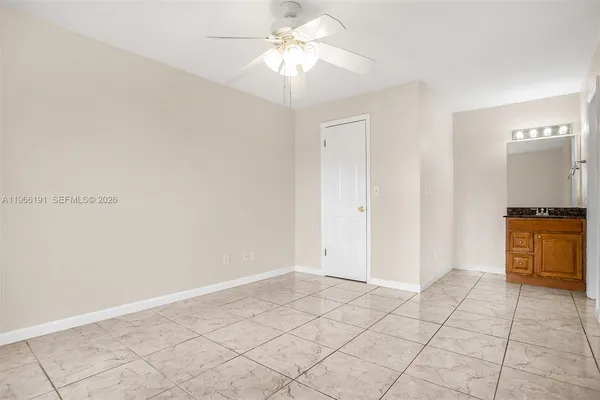 a view of a kitchen with a sink and a chandelier fan