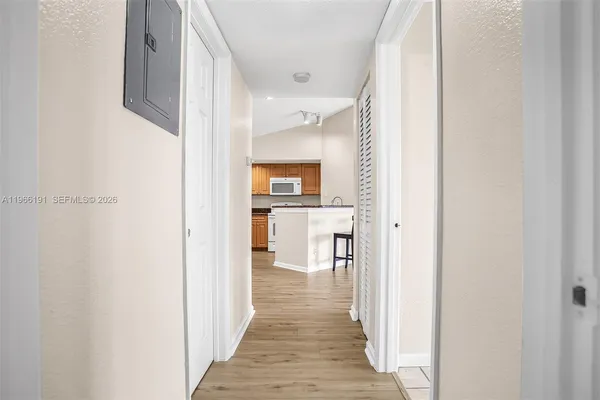 an empty room with wooden floor and white walls