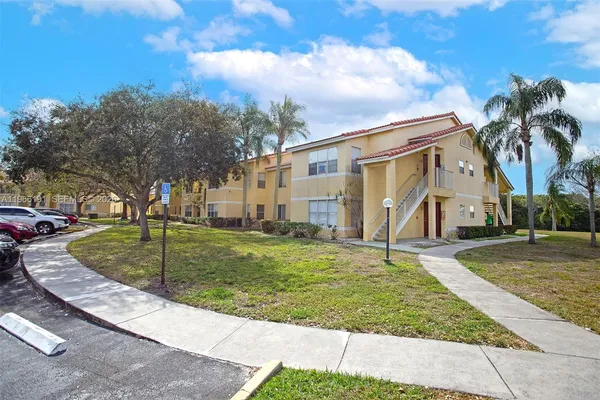 a view of a house with backyard and trees