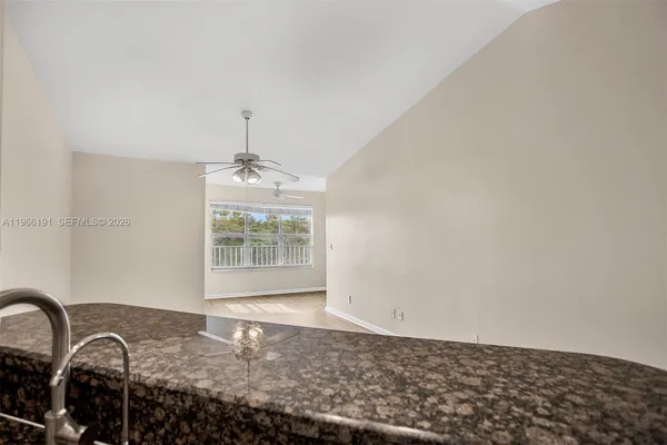 a view of a livingroom with wooden floor and a window