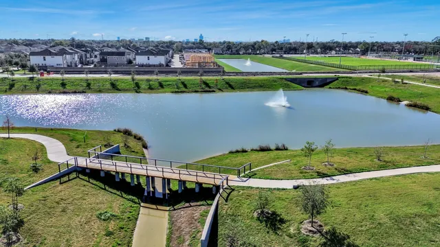 an aerial view of a house with a yard and lake view