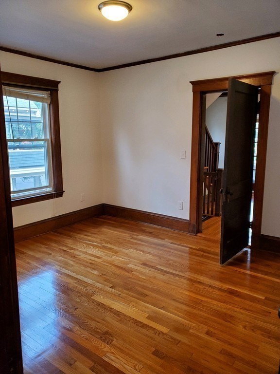 22 Allen Street, Unit 2 Arlington, MA 02474 - Photo 12 of 25 wooden floor in an empty room with a window