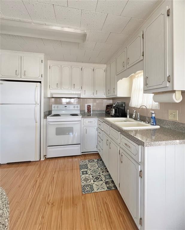 1100 South Belcher Road, Unit 270 Largo, FL 33771 - Photo 11 of 32 a kitchen with white cabinets and white appliances