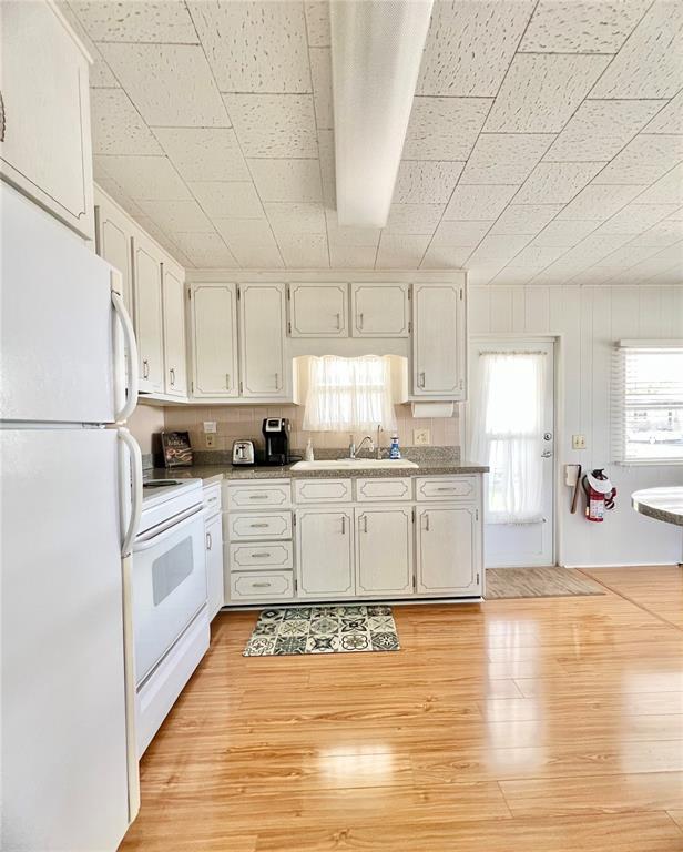 1100 South Belcher Road, Unit 270 Largo, FL 33771 - Photo 13 of 32 a kitchen with granite countertop white cabinets and white appliances
