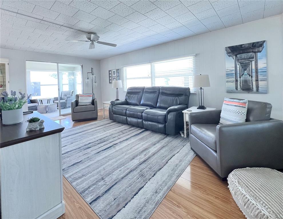 1100 South Belcher Road, Unit 270 Largo, FL 33771 - Photo 15 of 32 a living room with furniture and wooden floor