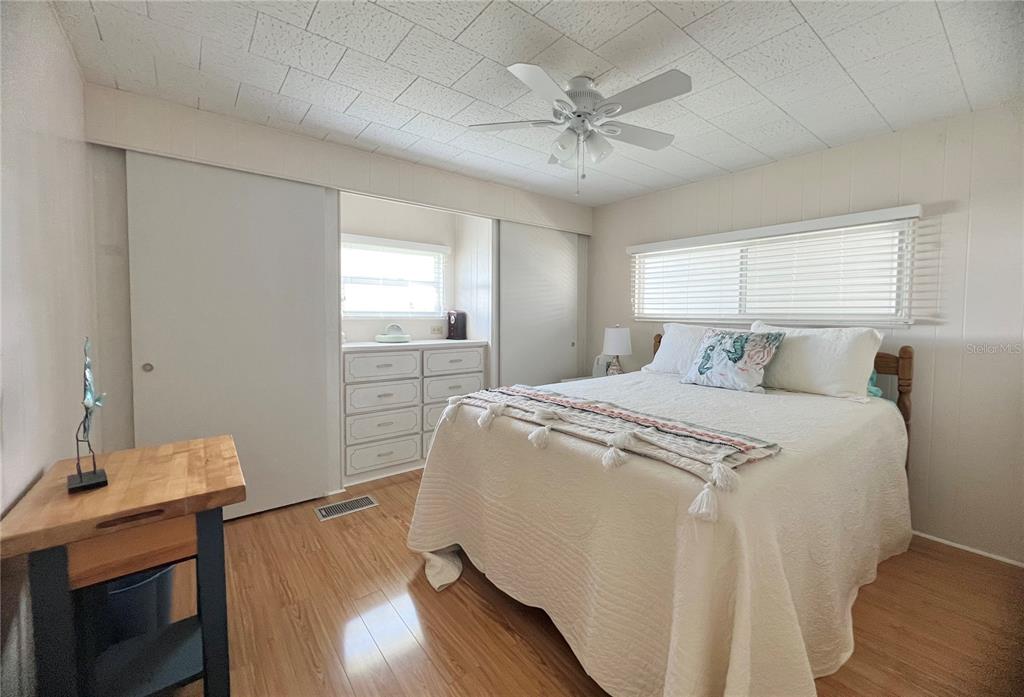 1100 South Belcher Road, Unit 270 Largo, FL 33771 - Photo 22 of 32 a bedroom with a bed and wooden floor