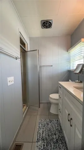 a bathroom with a toilet and a shower
