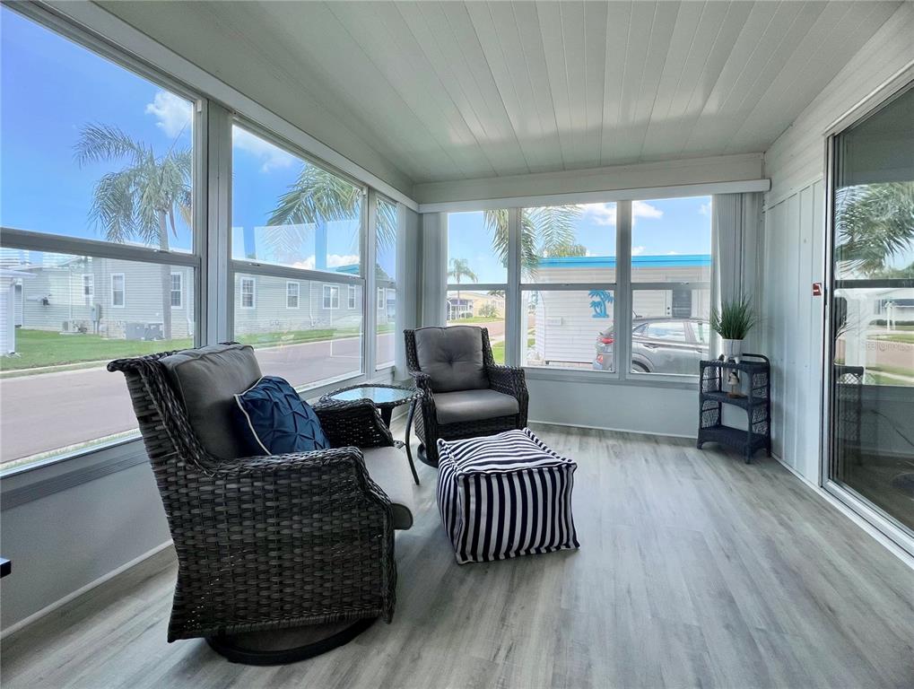 1100 South Belcher Road, Unit 270 Largo, FL 33771 - Photo 5 of 32 a living room with furniture and a floor to ceiling window