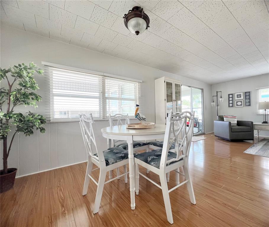 1100 South Belcher Road, Unit 270 Largo, FL 33771 - Photo 7 of 32 a dining room with furniture window wooden floor