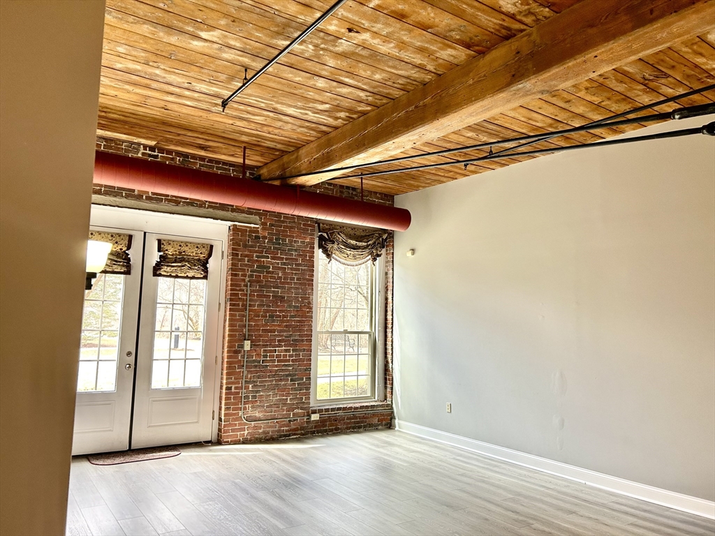 12 Brookside Road, Unit 3 Westford, MA 01886 - Photo 13 of 28 an empty room with wooden floor and windows
