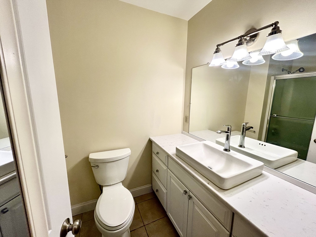 12 Brookside Road, Unit 3 Westford, MA 01886 - Photo 22 of 28 a bathroom with a sink mirror vanity and toilet