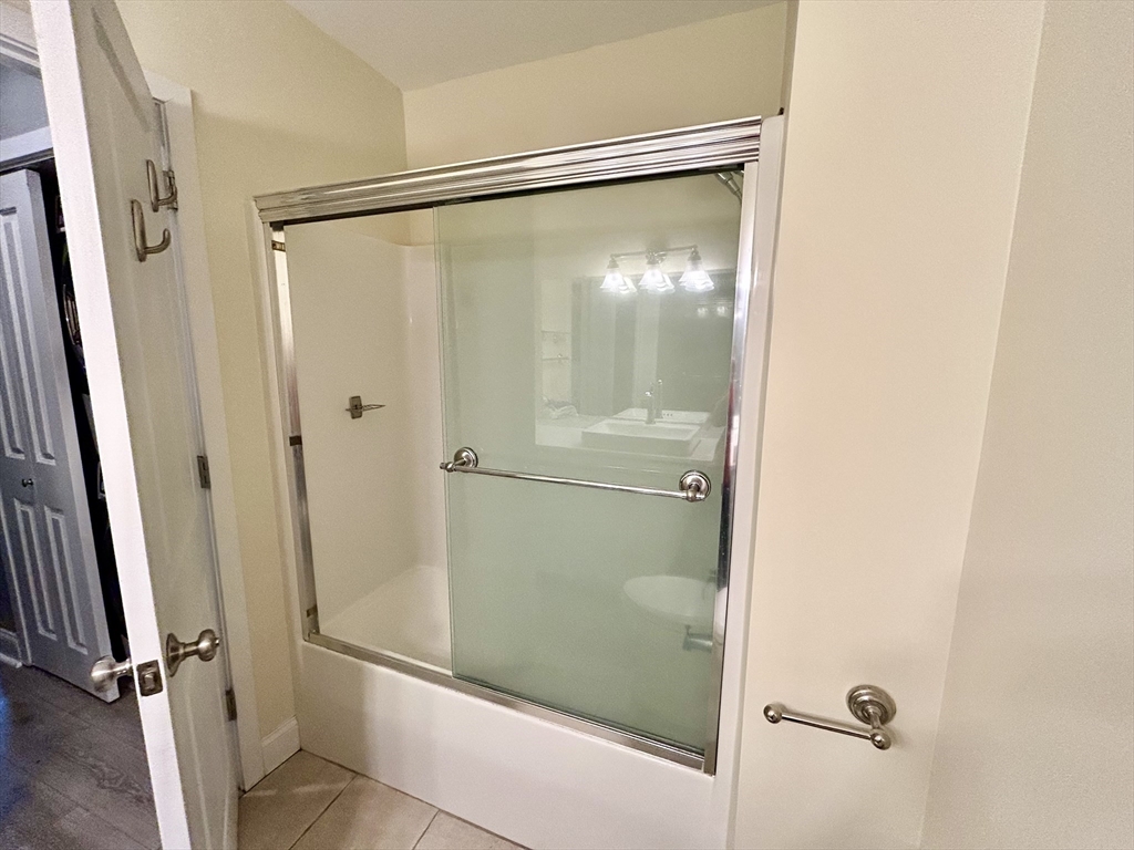 12 Brookside Road, Unit 3 Westford, MA 01886 - Photo 23 of 28 a bathroom with a glass shower door