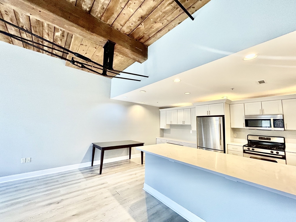 12 Brookside Road, Unit 3 Westford, MA 01886 - Photo 5 of 28 a view of kitchen with furniture and stainless steel appliances